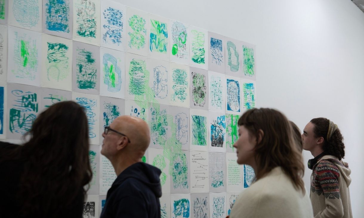 Gallery visitors viewing prints