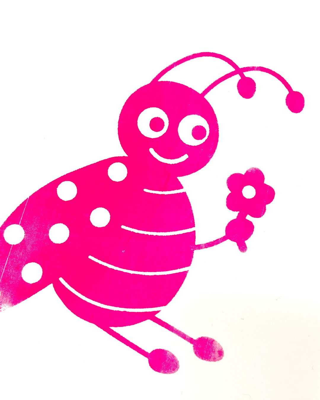 Pink screen print of a smiling ladybird holding a flower
